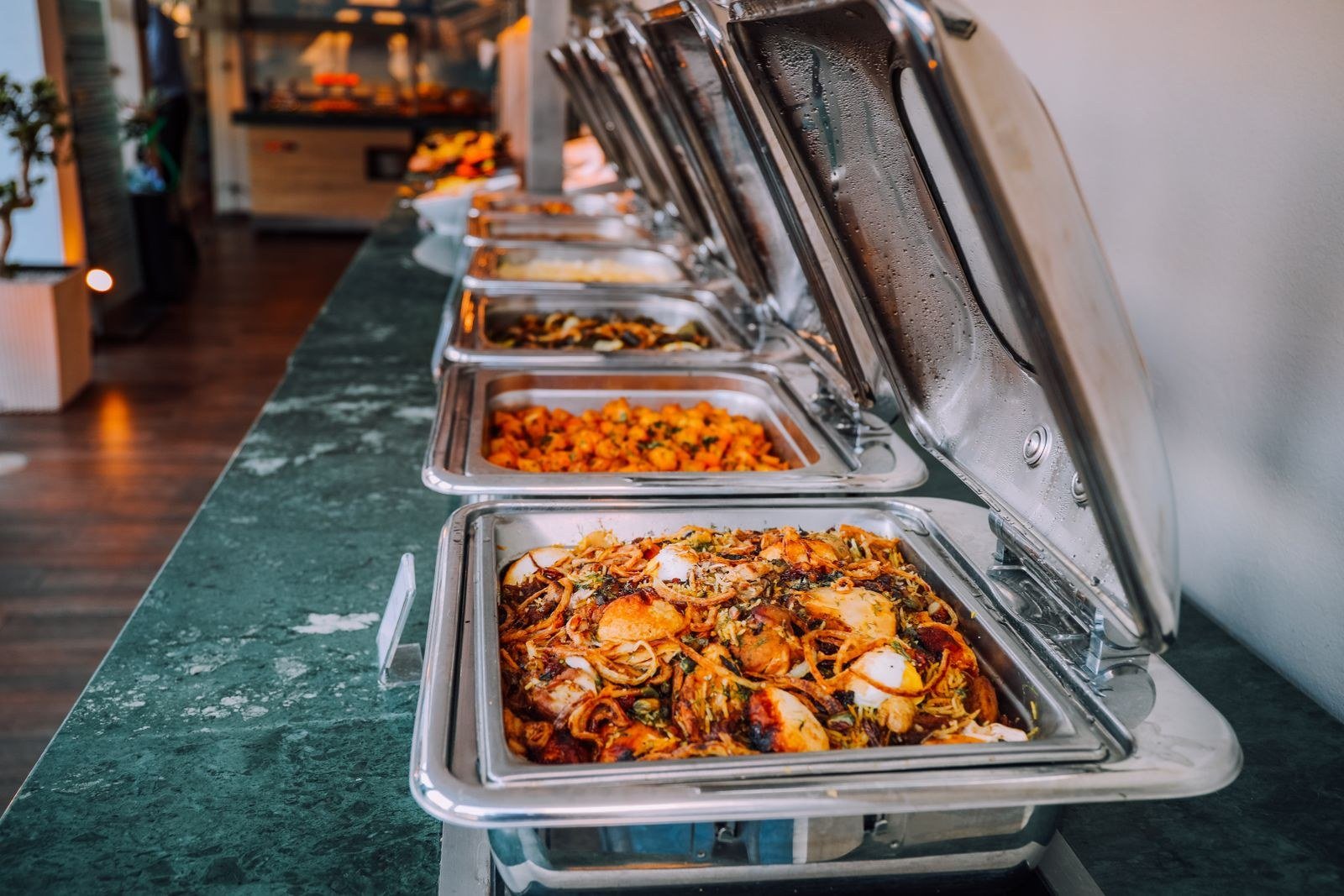 Indian wedding food buffet setup with chafing dishes